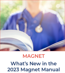Nurse holding an open book | MAGNET What's New in the 2023 Magnet Manual